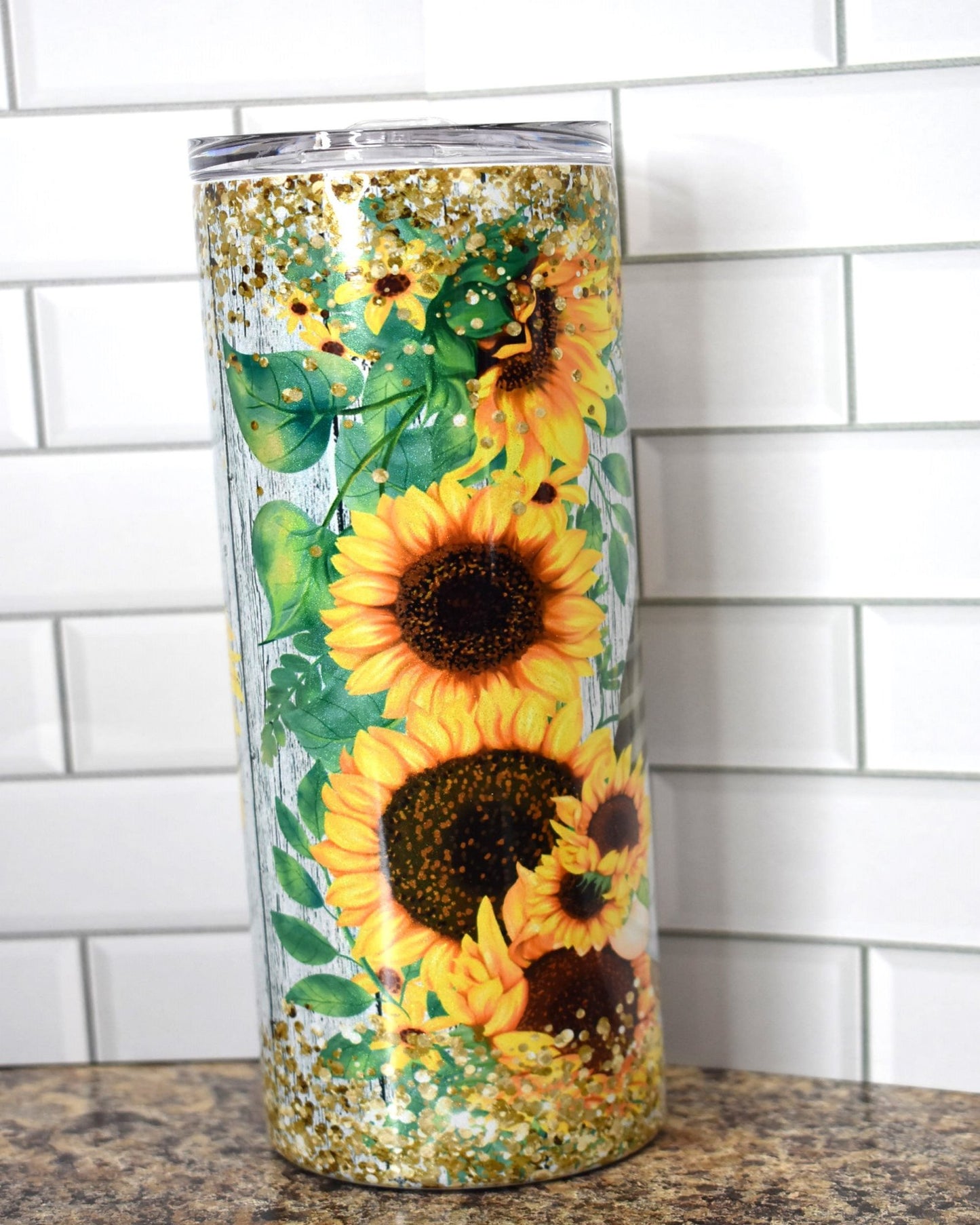20 oz Makerflo Stainless Steel Tumbler With Gnomes Enjoying Sunflowers with chunky gold glitter flakes top & bottom. We put this image on our holographic glitter series
