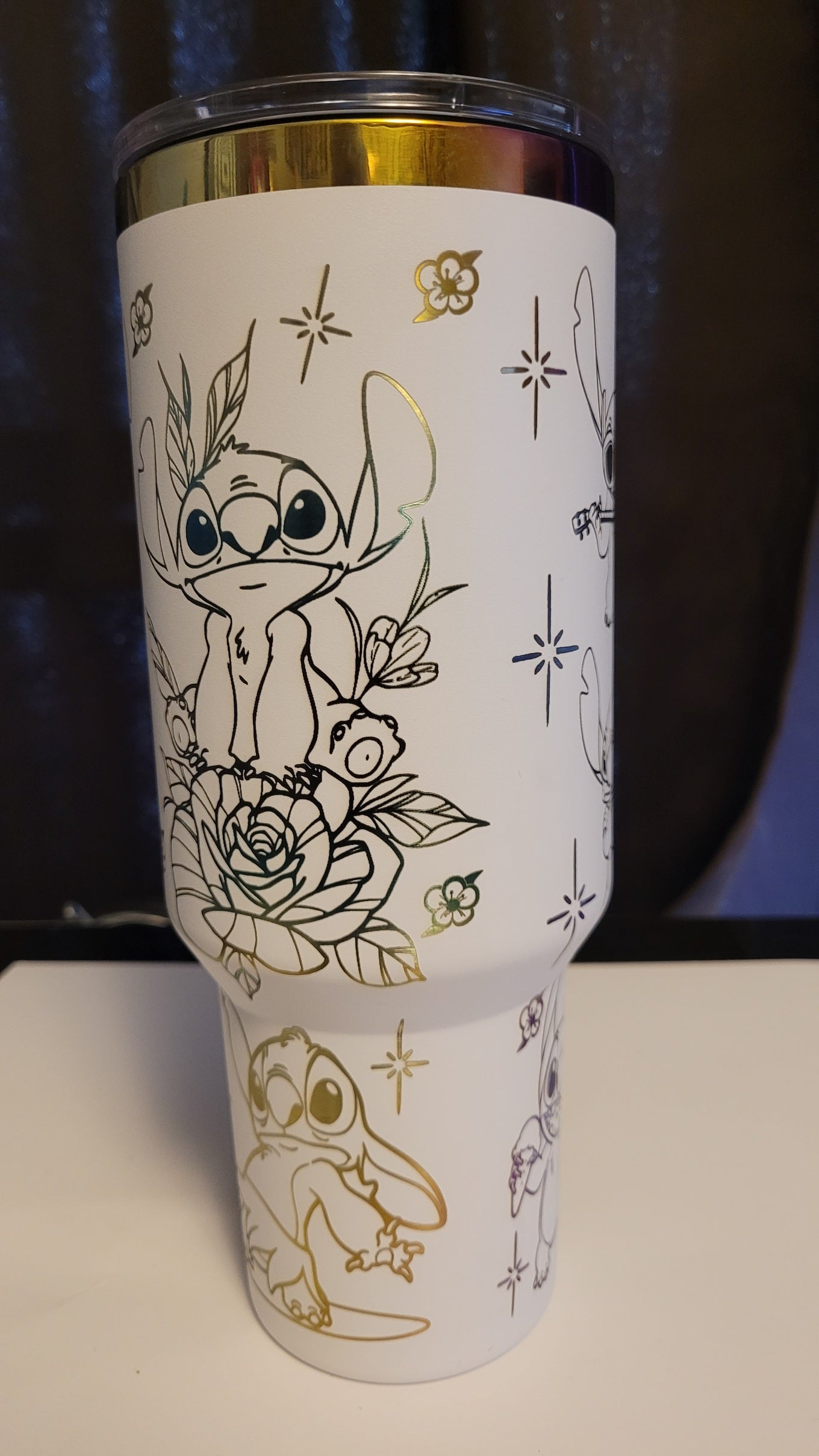 Introducing the latest addition to our collection: the 40 oz Gold Plated Tumbler featuring laser-etched full-wrap from another on a sleek white background.