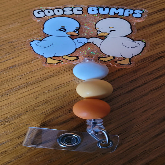 Goose Bumps, and not the ones you get from a good scare. These are 2 little geese giving each other fist bumps. With an orange glitter background and 3 color coordinated matching silicone beads this one is sure to please.