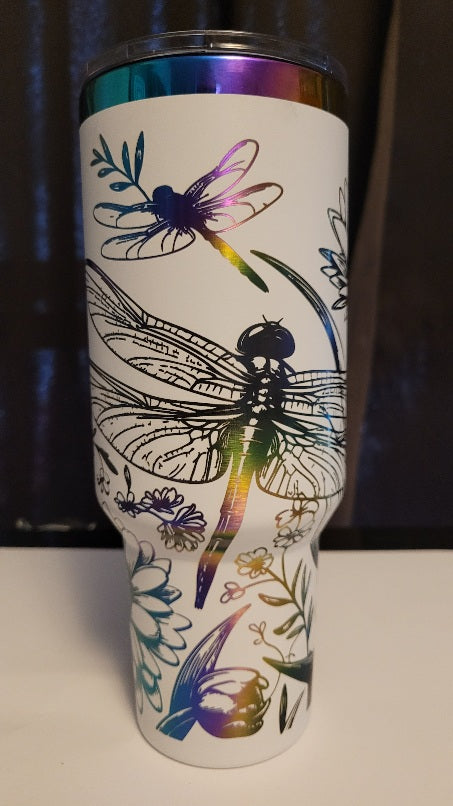 Introducing the latest addition to our collection: the 40 oz Gold Plated Tumbler featuring laser-etched full-wrap from another on a sleek white background. Features 2 dragonflies amongst various flowers