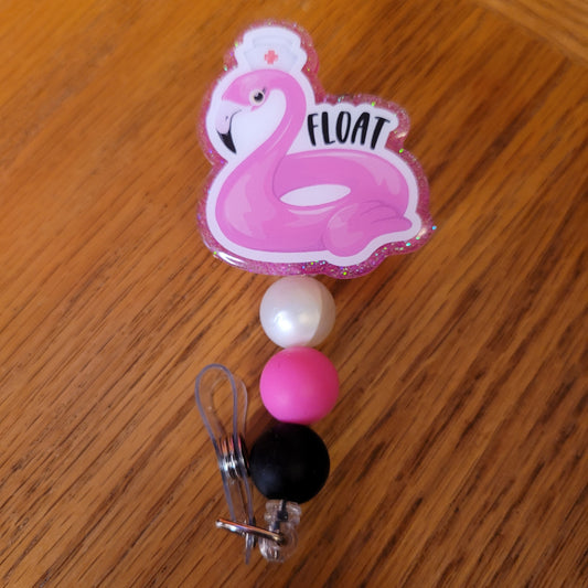 Another new one to our Animal Series... Flamingo Float. For those that "Float" from department to department this cute badge reel is for you. A pink flamingo float wearing a nurses hat and a pink glitter backing and 3 color-coordinated silicone beads add the perfect finishing touch to this badge reel.