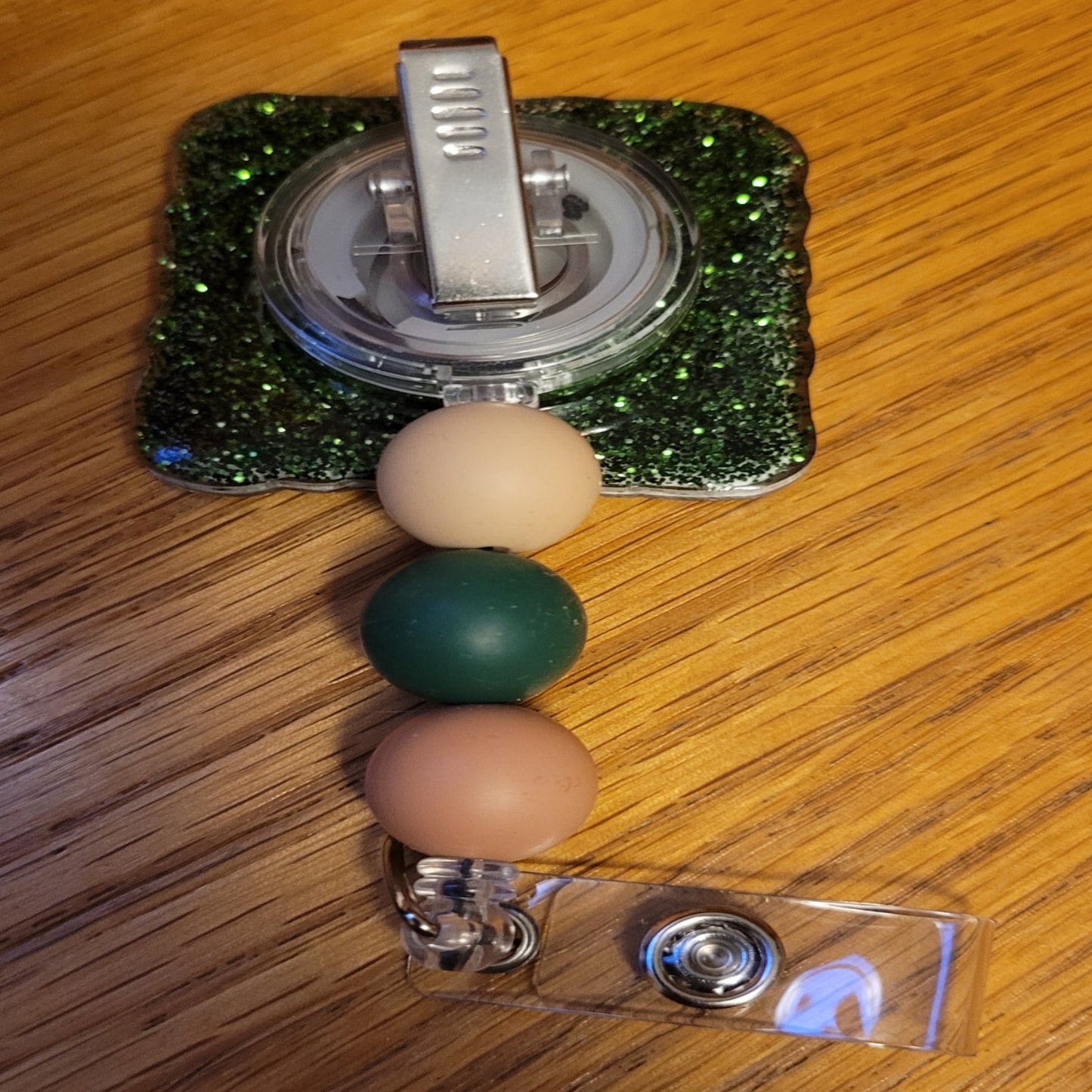 Here is Outdoors. This badge reel has everything from a largemouth bass, dream whitetail buck and flocks of mallards with an image of a person in a boat on a quite lake deep in the woods with a mountain range in the backdrop. It is finished with a green glitter base and three carefully chosen silicone beads.