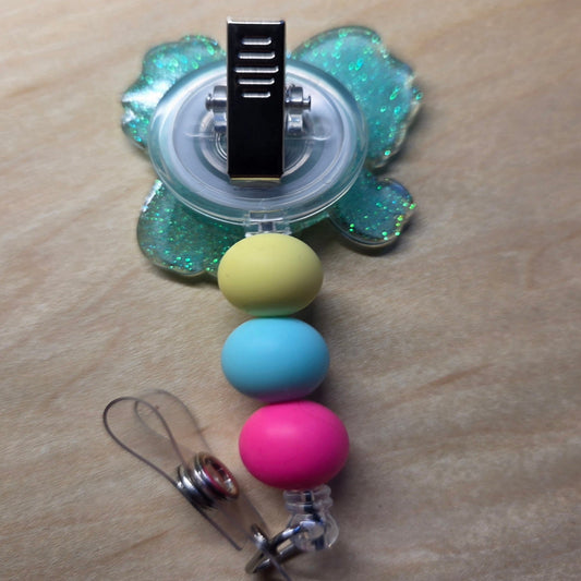 Colorful beaded keychain with a clear holder on a wooden surface