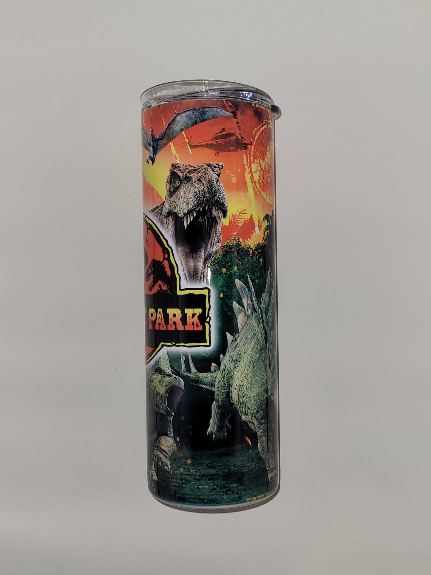 20 oz Stainless Steel tumbler with a T-Rex & dinosaurs fleeing erupting volcano.