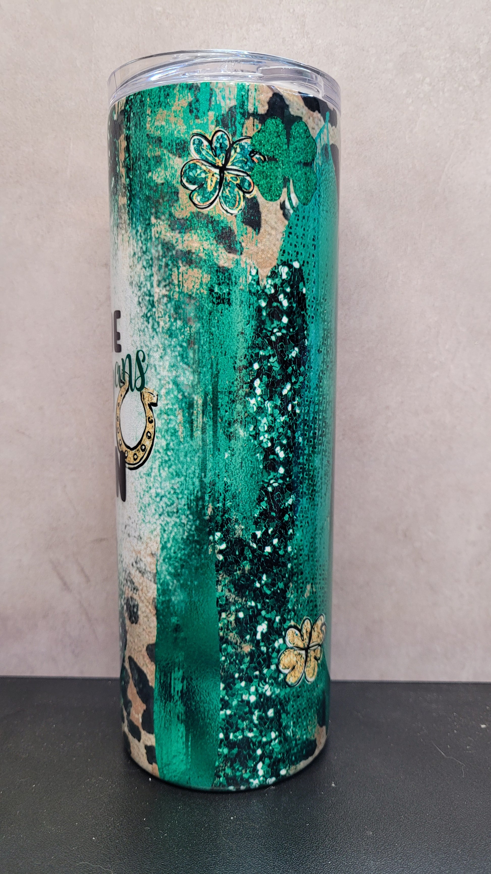 Let The Shenanigans Begin! This 20 oz tumbler features that phrase over a cheetah print background with splashes of Irish greens and luck charms.