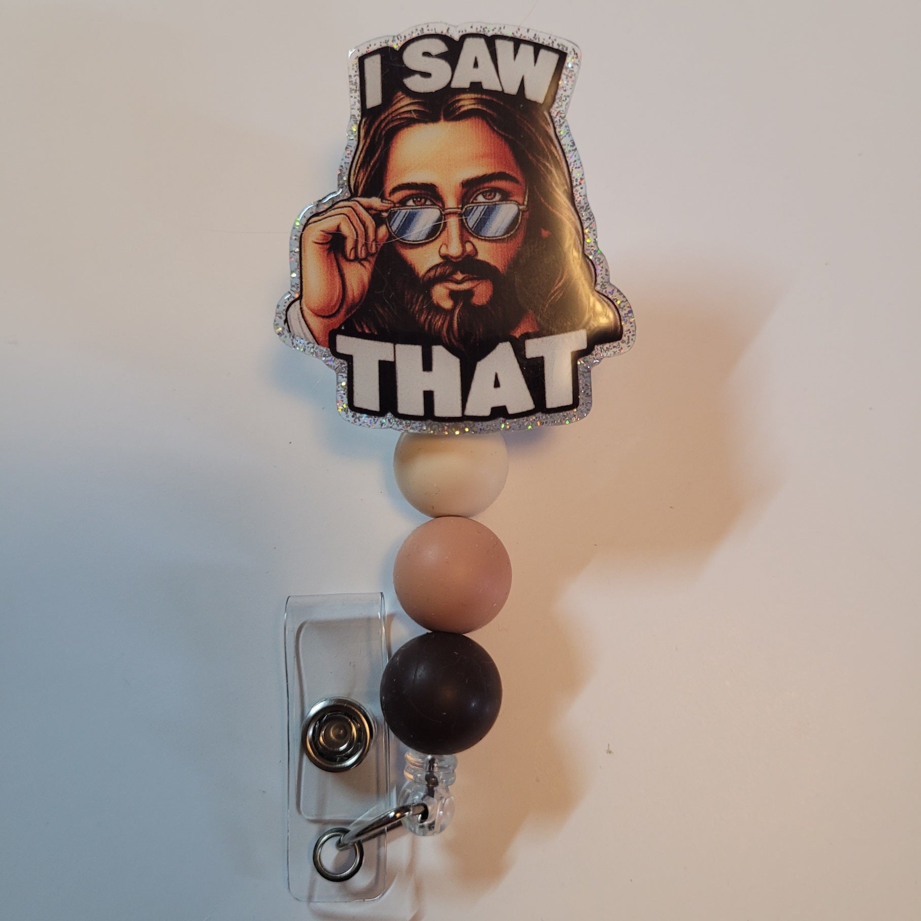 Badge holder with a cartoon character and 'I Saw That' text on a white background