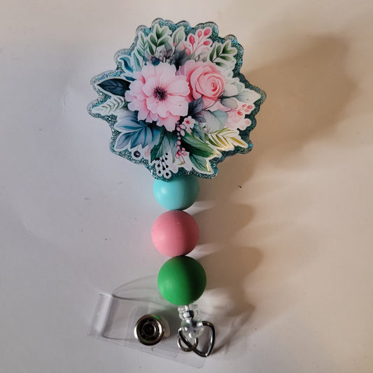 Decorative badge holder with floral design and colorful beads on a white background