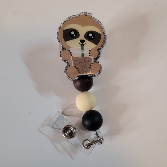 Sloth-themed badge holder with colorful beads on a white background