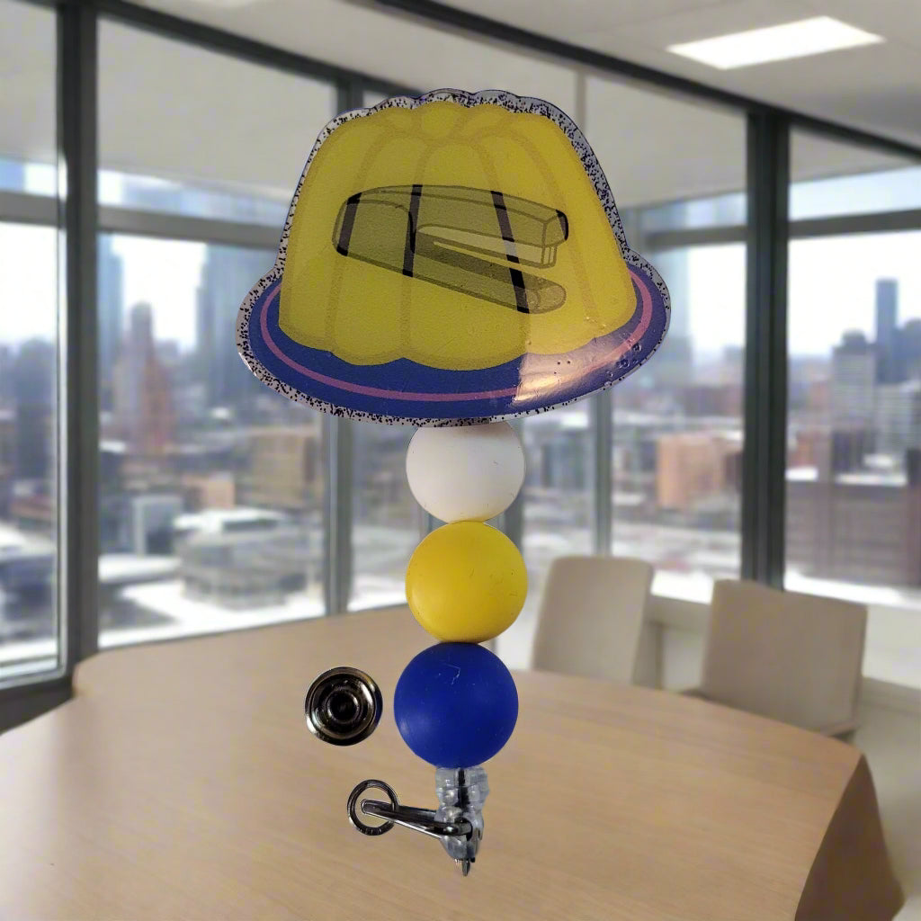 Colorful badge holder with a yellow hat design on a white background