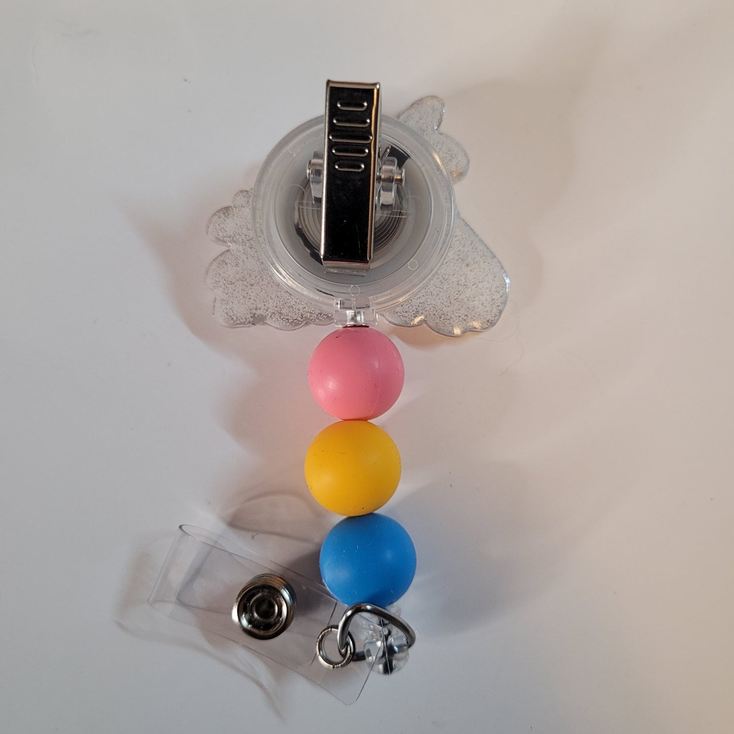Retractable badge holder with colorful beads on a white background