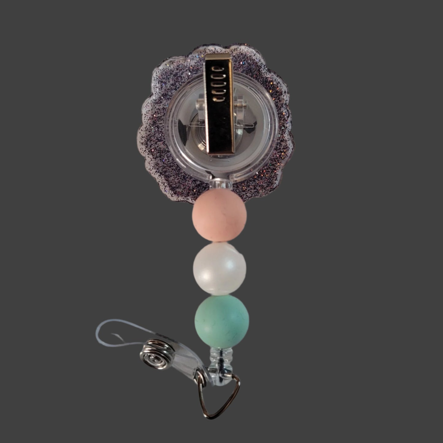 Badge holder with colorful beads and decorative clasp on a white background