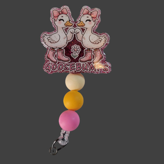 Badge holder with cartoon ducks and 'GOOSEBUMPS' text on a white background