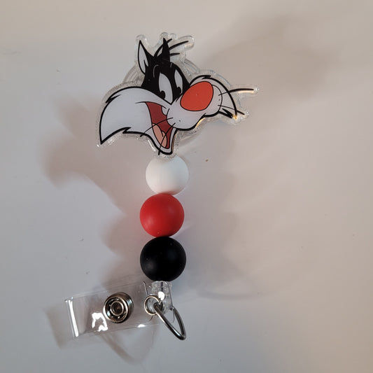 Cartoon character badge holder with colorful beads on a white background