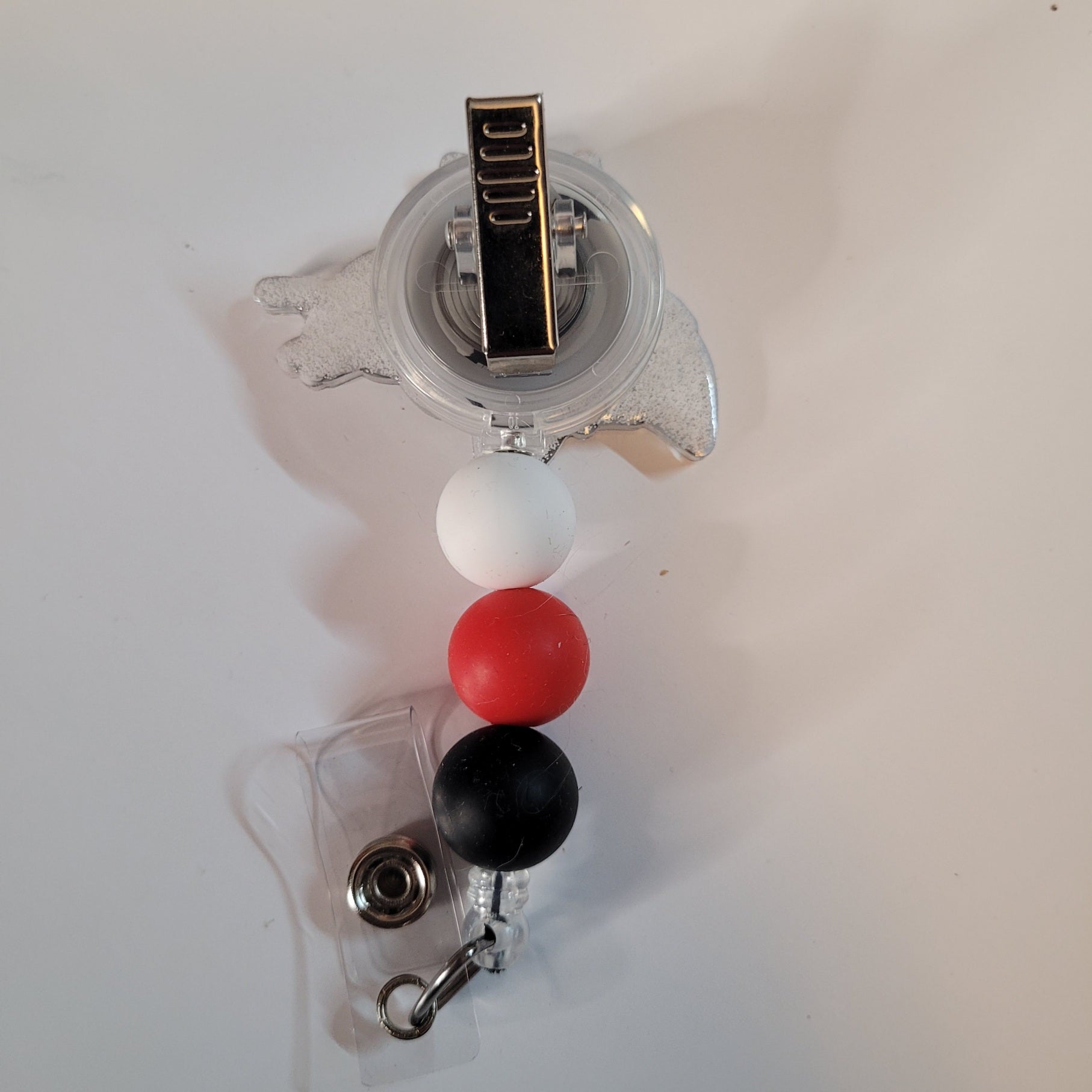 Retractable badge holder with colorful beads on a white background