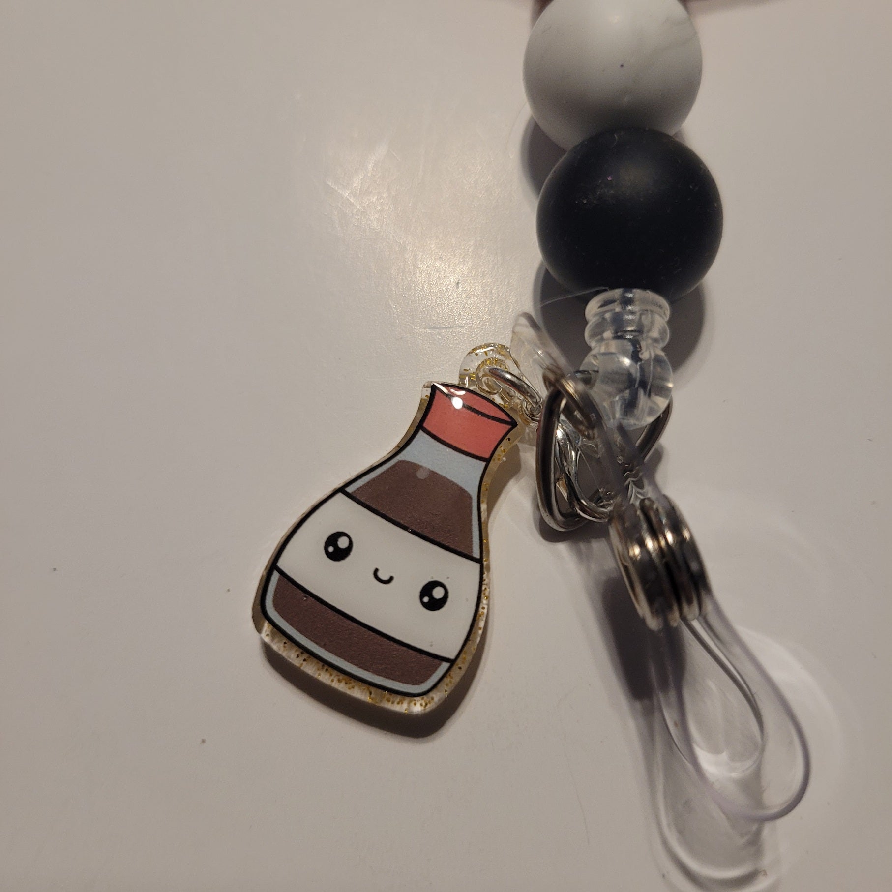 Lanyard with a cute bottle charm on a white background