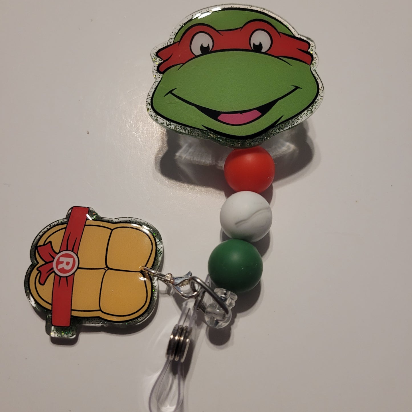 Retractable badge holder with turtle design on a white background