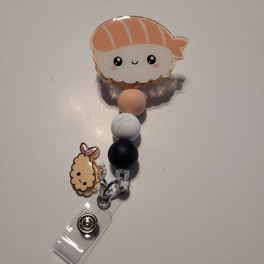 Retractable badge holder with cartoon character charm on a white background
