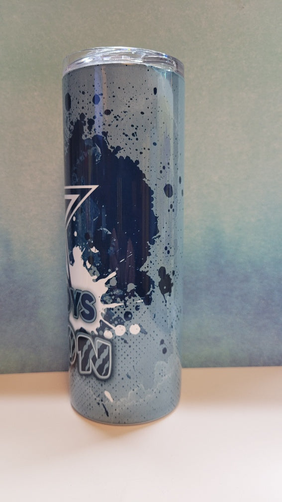 Tumbler with blue splatter design and cowboys
