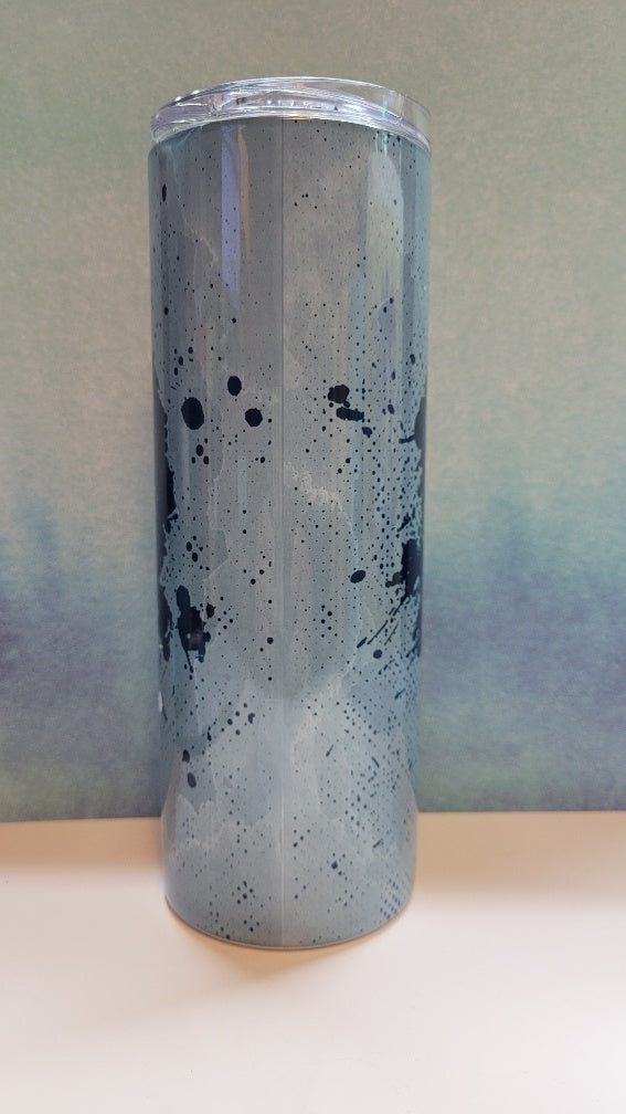 Tumbler with blue splatter design and cowboys