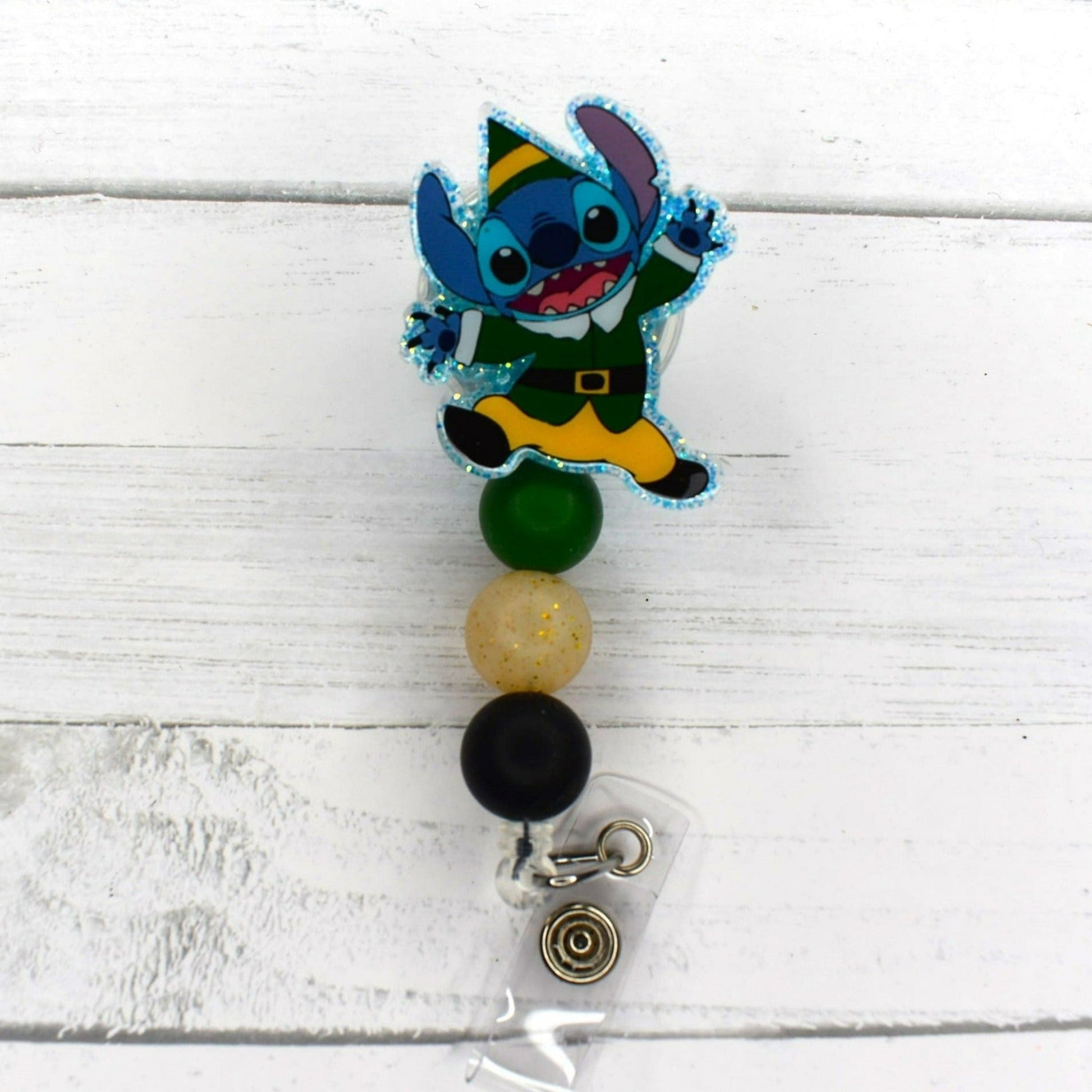 This badge reel features Experiment 626 enjoying Christmas. 4 different versions available. All badge reels feature a glitter base and color coordinated beads.