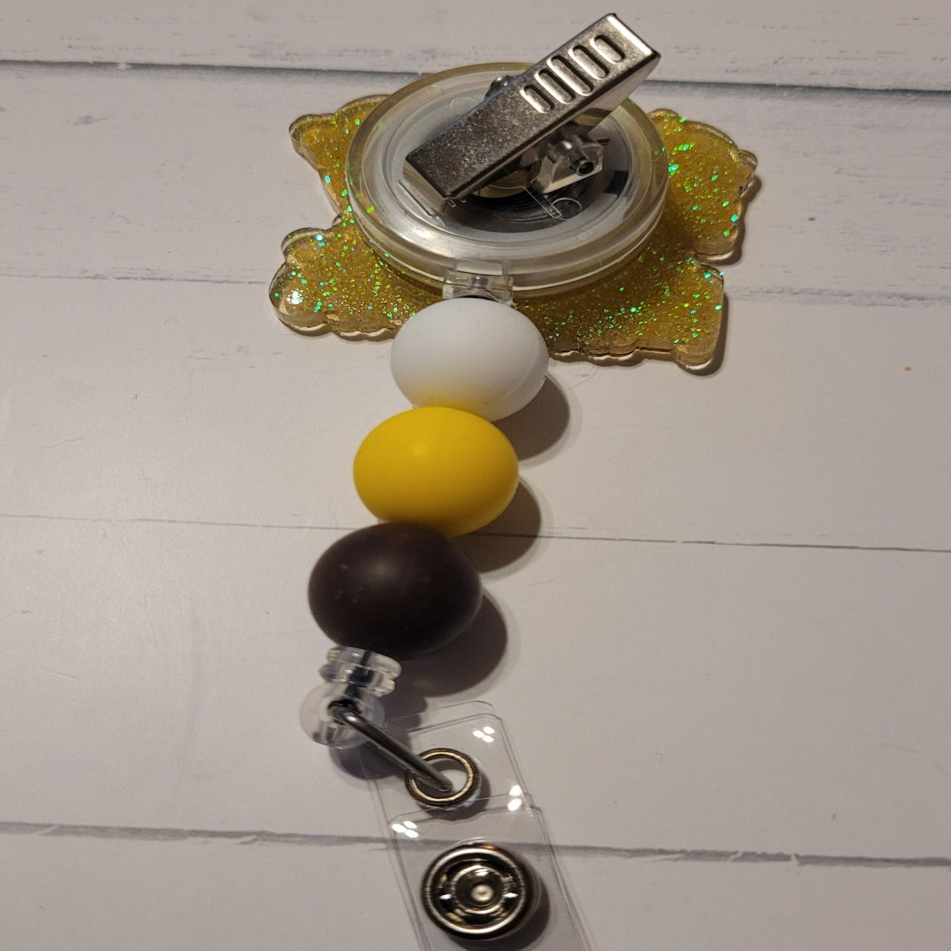 Bananas....Yes that crazy shift that is absolutely Bananas. We bring you yet another new addition to our Medical Series Badge Reels. This Shift Is Bananas. 2 cool bananas wearing sunglasses on the front with yellow glitter on the back with color coordinating silicone beads to finish the craziness. Plays well with our Night Shift Era Badge Reel.