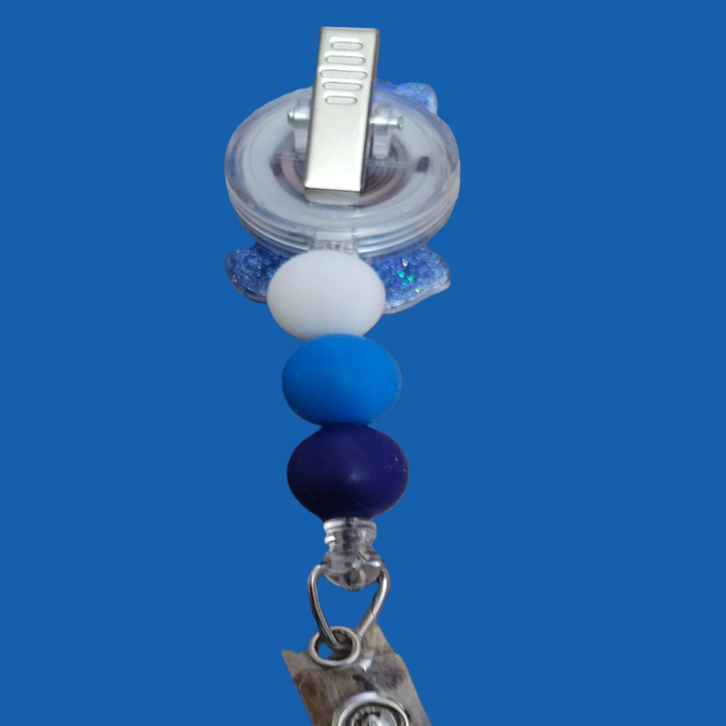 Looking for a charming badge reel? Well, look no further because we've got our Grumpy Bear here! With a glittery blue back and 3 matching silicone beads, it's perfect for all the bear lovers out there. This is 1 of 5 variations.