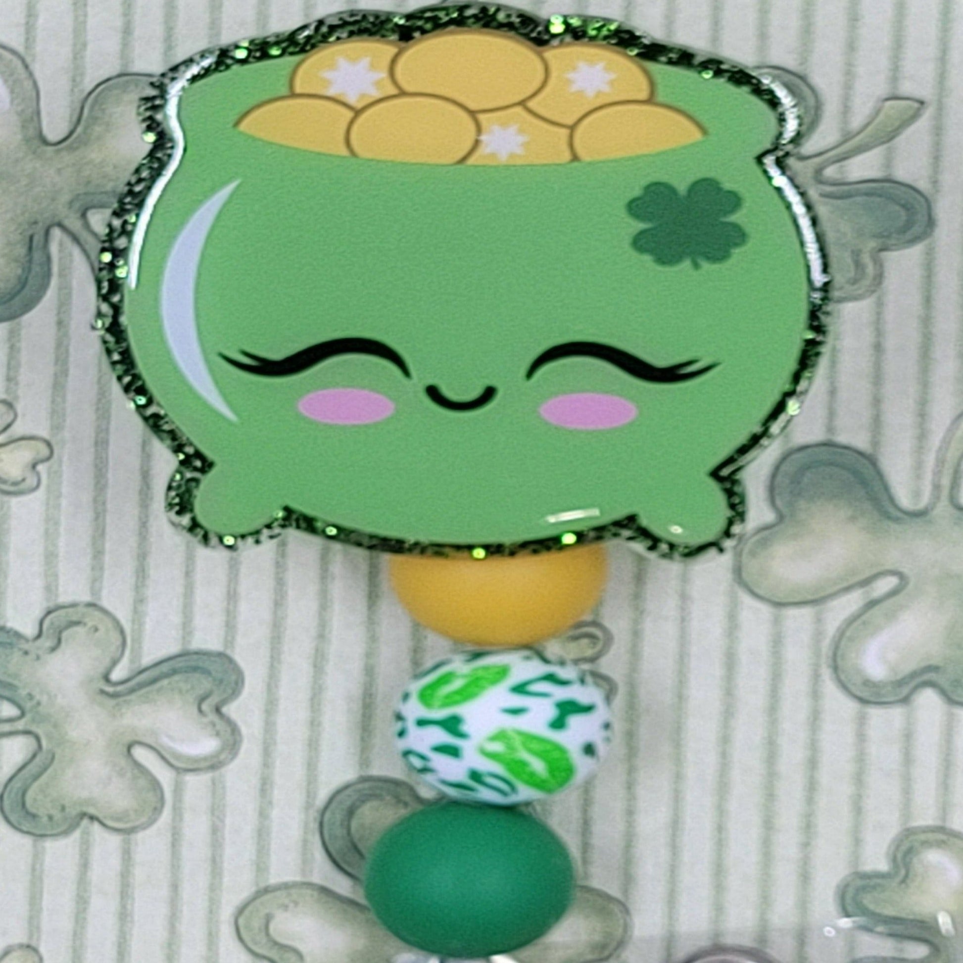 Celebrate St. Patrick's Day with our Happy Pot Of Gold badge reel. This charming pot is filled with gold and features a dark green glitter base and 3 coordinating silicone beads for a festive, professional look.