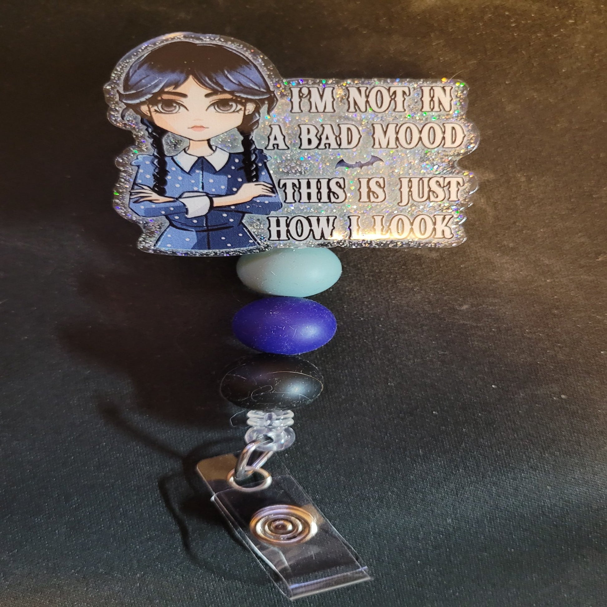 I'm not in a bad mood, This is just how I look. Our favorite girl Wednesday makes an appearance here. A clear glitter base with 3 color matching beads will finish the mood.
