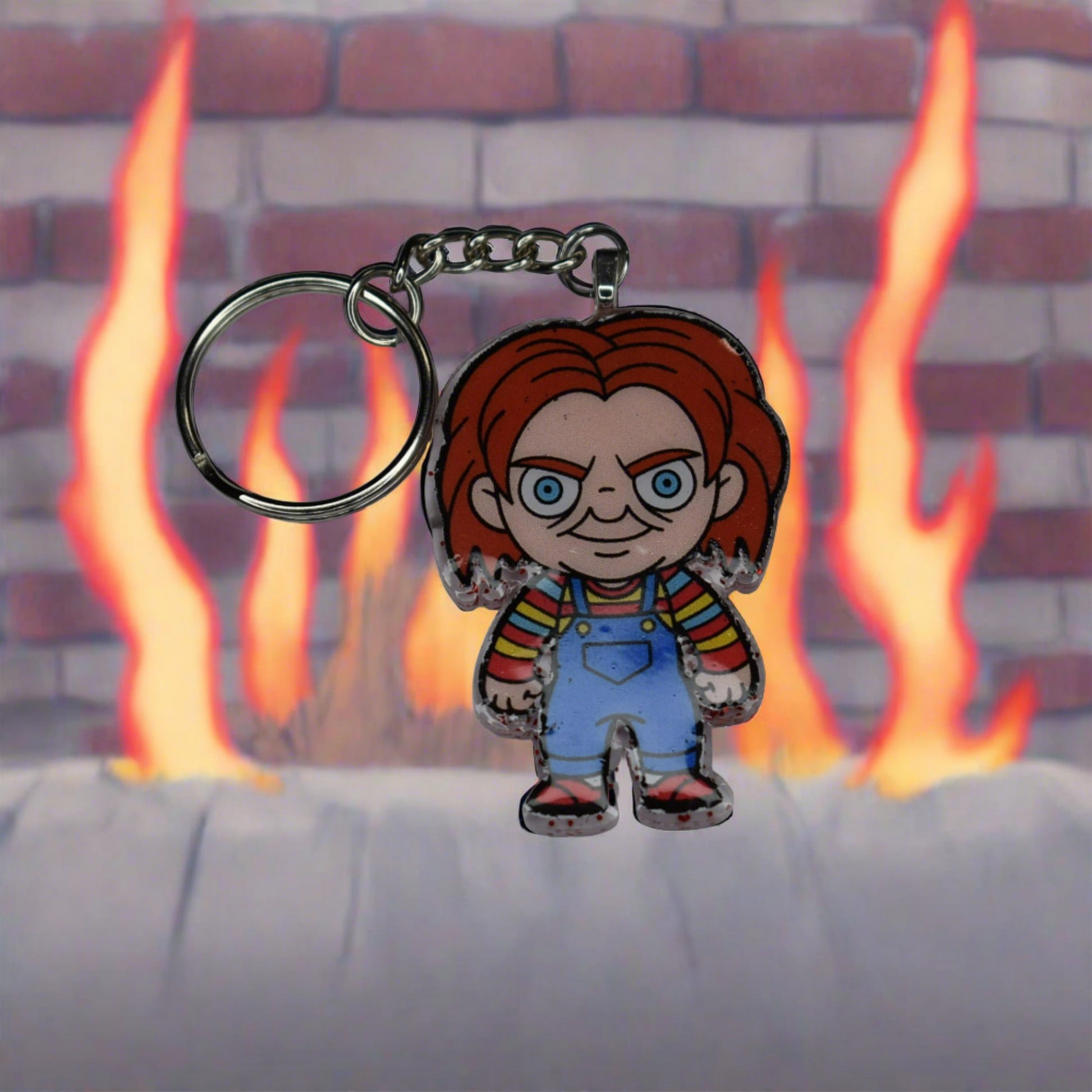 From our Horror Collection here is Chucky. There is nothing good about this guy. Trapped in a doll he craves to kill to regain his human form. This Keychain features a Blood red glitter back and that crazy red headed doll in overhauls on the front. Hand crafted from acrylic resin to be strong, like Chucky's need and desire to kill.