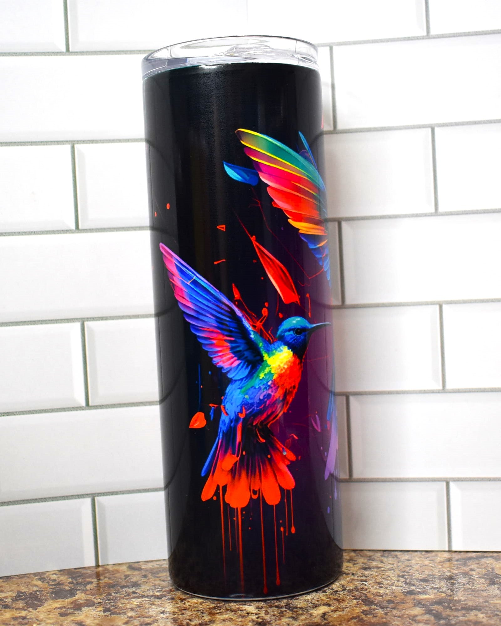 Hummingbirds dripping of paint are featured here on this Makerflo 20 oz tumbler. 