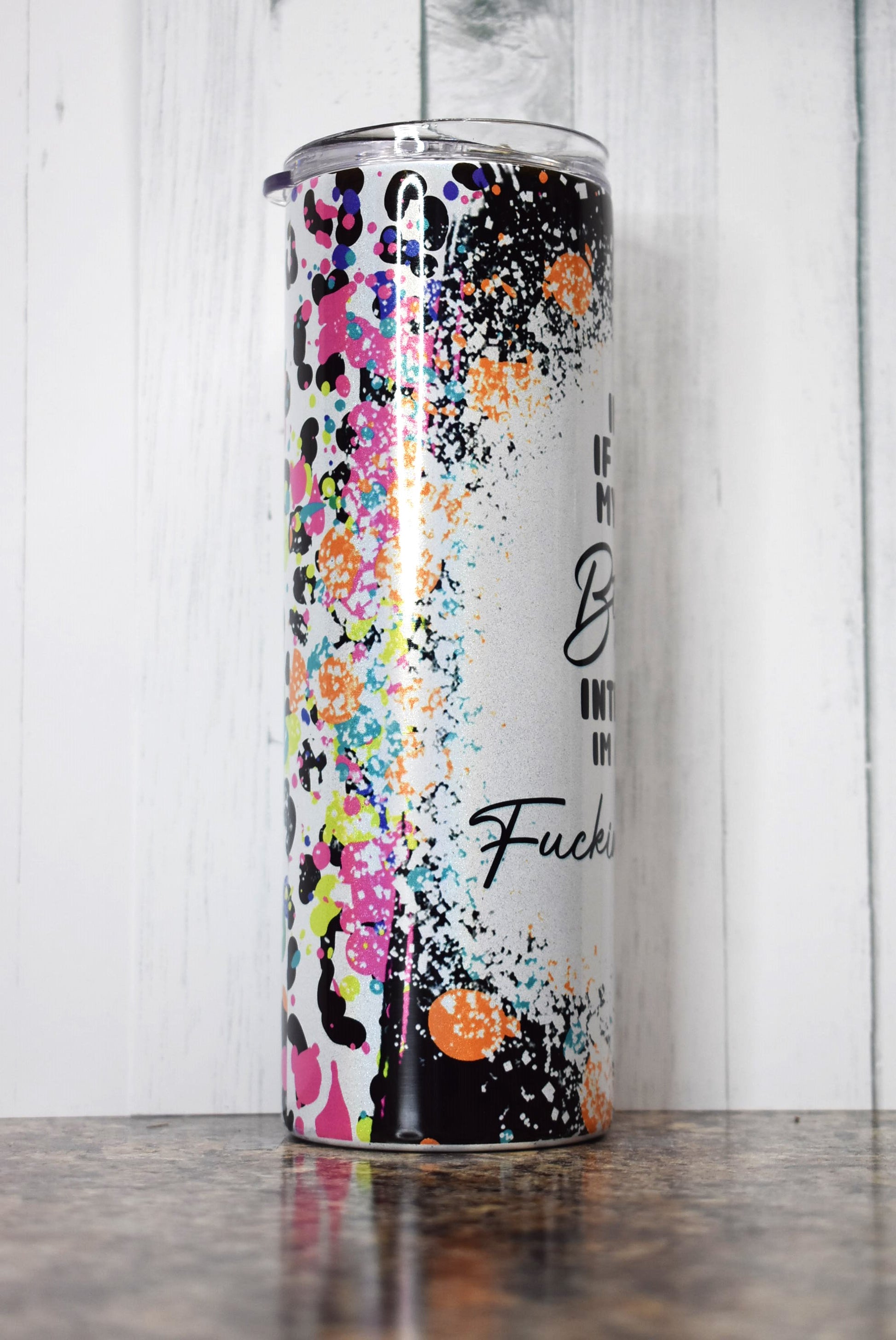 This 20 oz stainless steel Makerflo tumbler features colorful background image with a white splatter paint section with the phrase I'm Sorry If You Find My Resting Bitch Face Intimidating I'm Actually A Fucking Delight. 