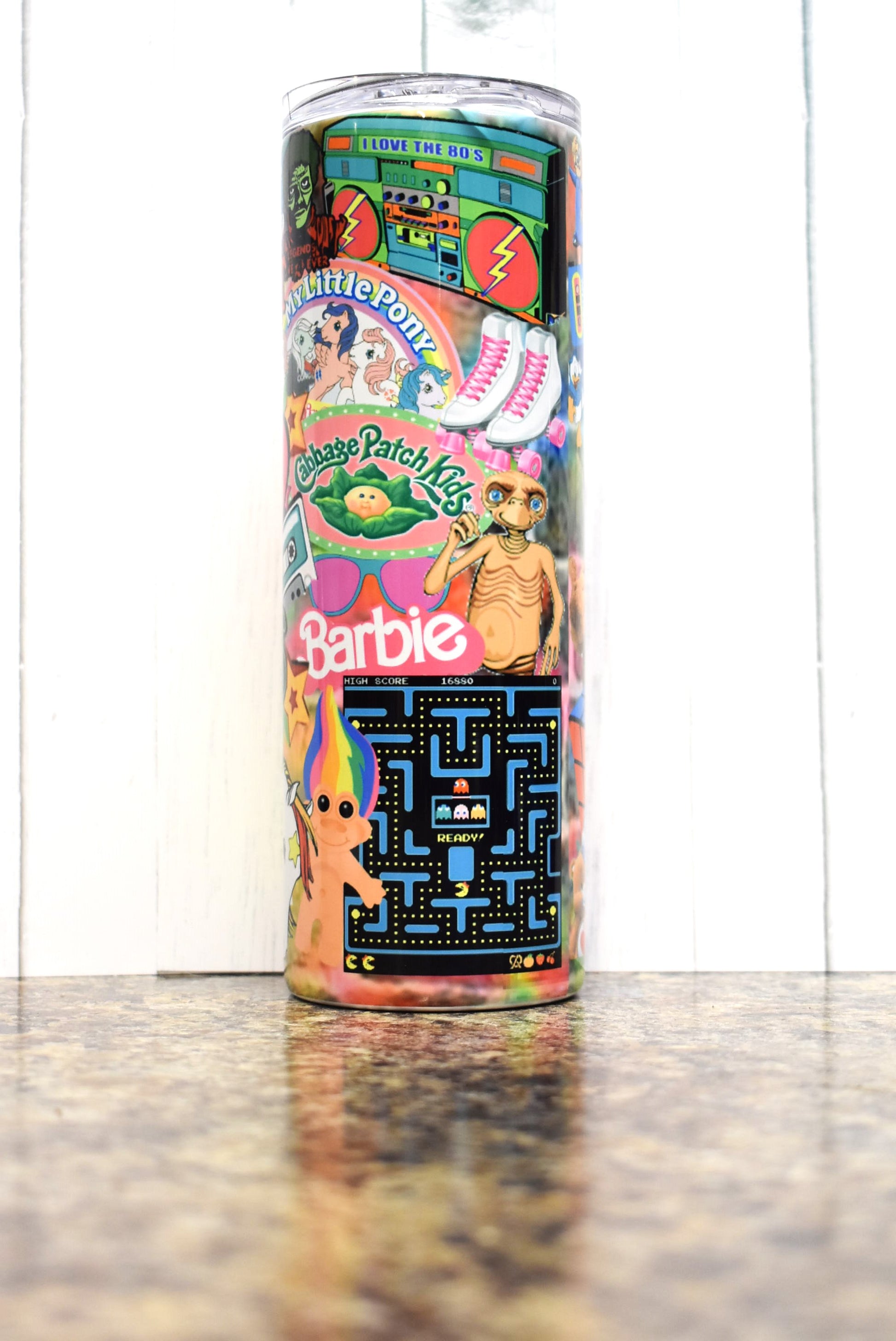 Turn back the clock to the 80s with this 20 oz tumbler. A stroll down memory lane as you pick out the many different iconic things from that decade. Sure to put a smile on your face. 