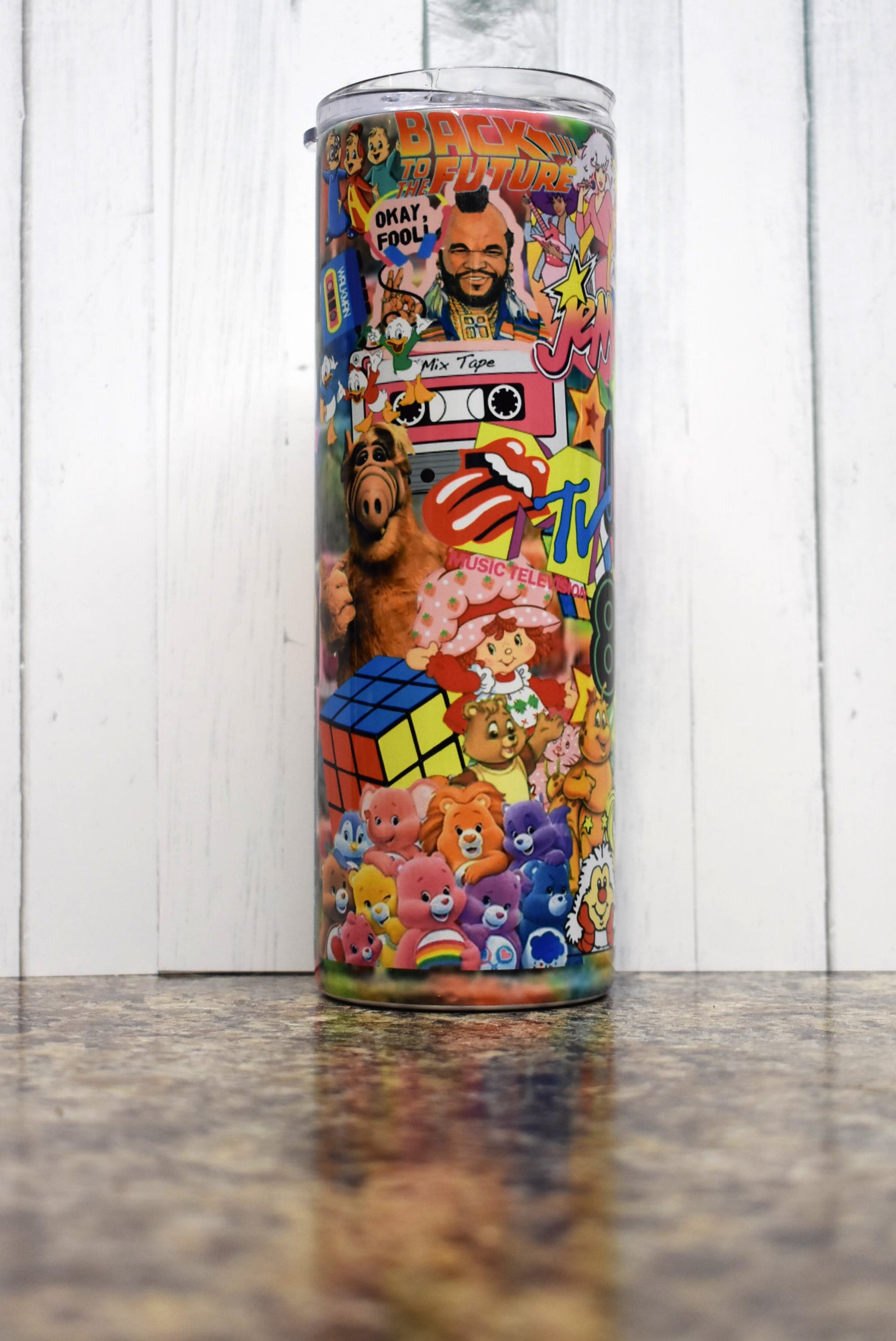 Turn back the clock to the 80s with this 20 oz tumbler. A stroll down memory lane as you pick out the many different iconic things from that decade. Sure to put a smile on your face. 