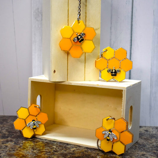 These Keychains are as busy as bees. With a Honey Comb pattern, glitter backs, and a sturdy acrylic resin material, you'll be buzzing with joy. Choose from 2 bee styles - a 2 wing or a 4 wing option.