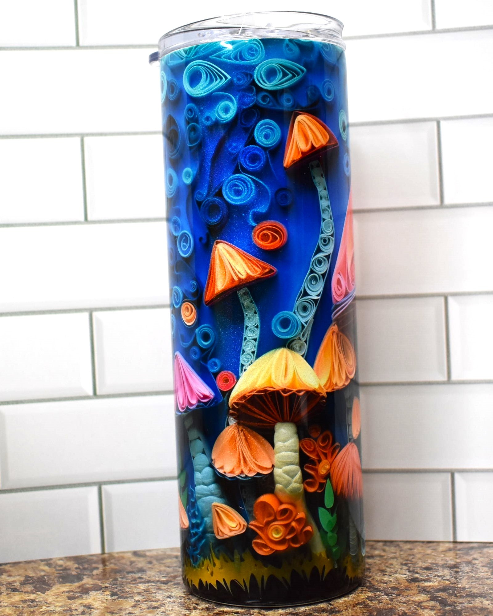 This tumbler is for the Fungi. All sorts of mushrooms in 3D adorn this tumbler on a blue background.