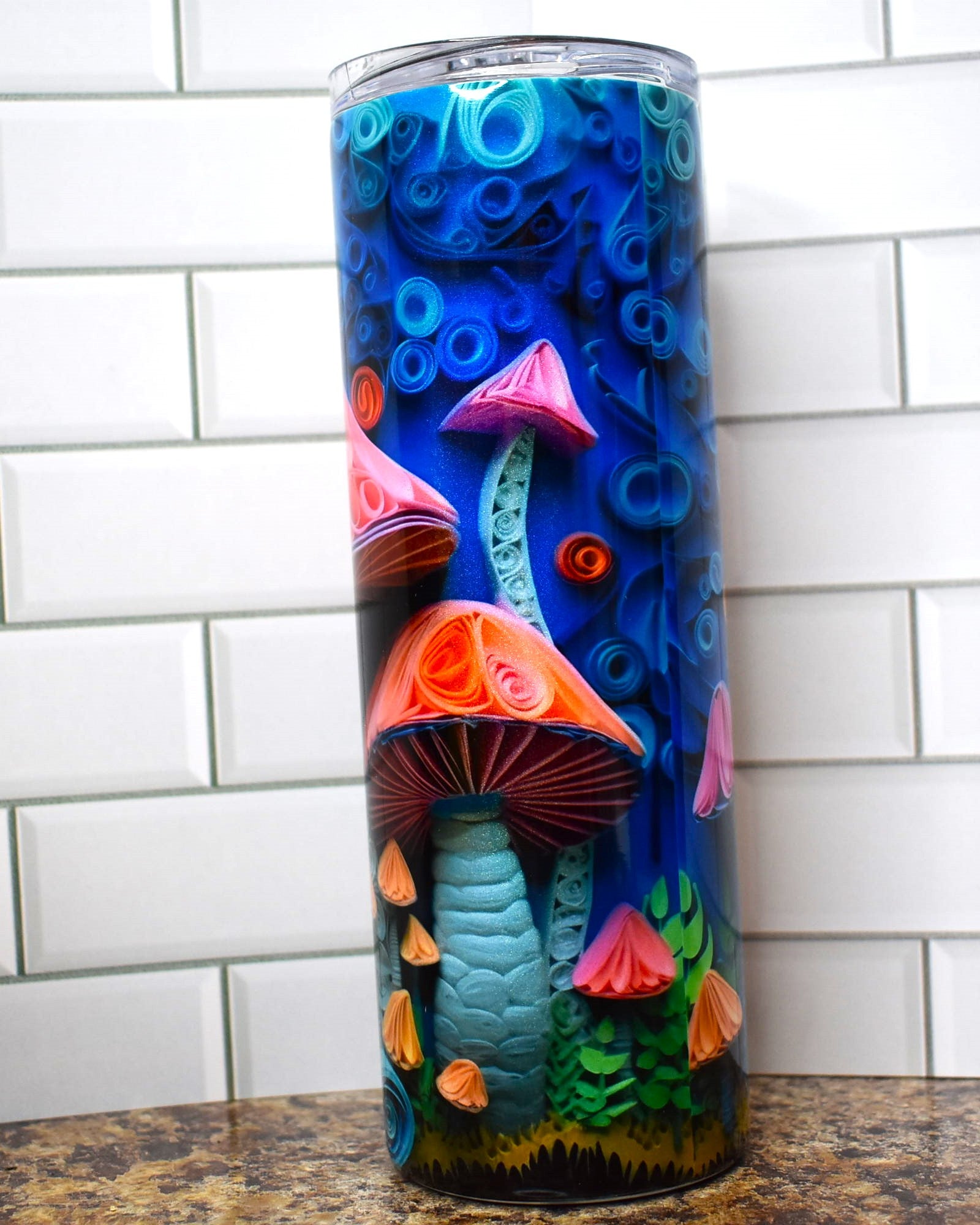 This tumbler is for the Fungi. All sorts of mushrooms in 3D adorn this tumbler on a blue background.