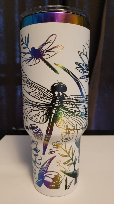 Introducing the latest addition to our collection: the 40 oz Gold Plated Tumbler featuring laser-etched full-wrap from another on a sleek white background. Features 2 dragonflies amongst various flowers