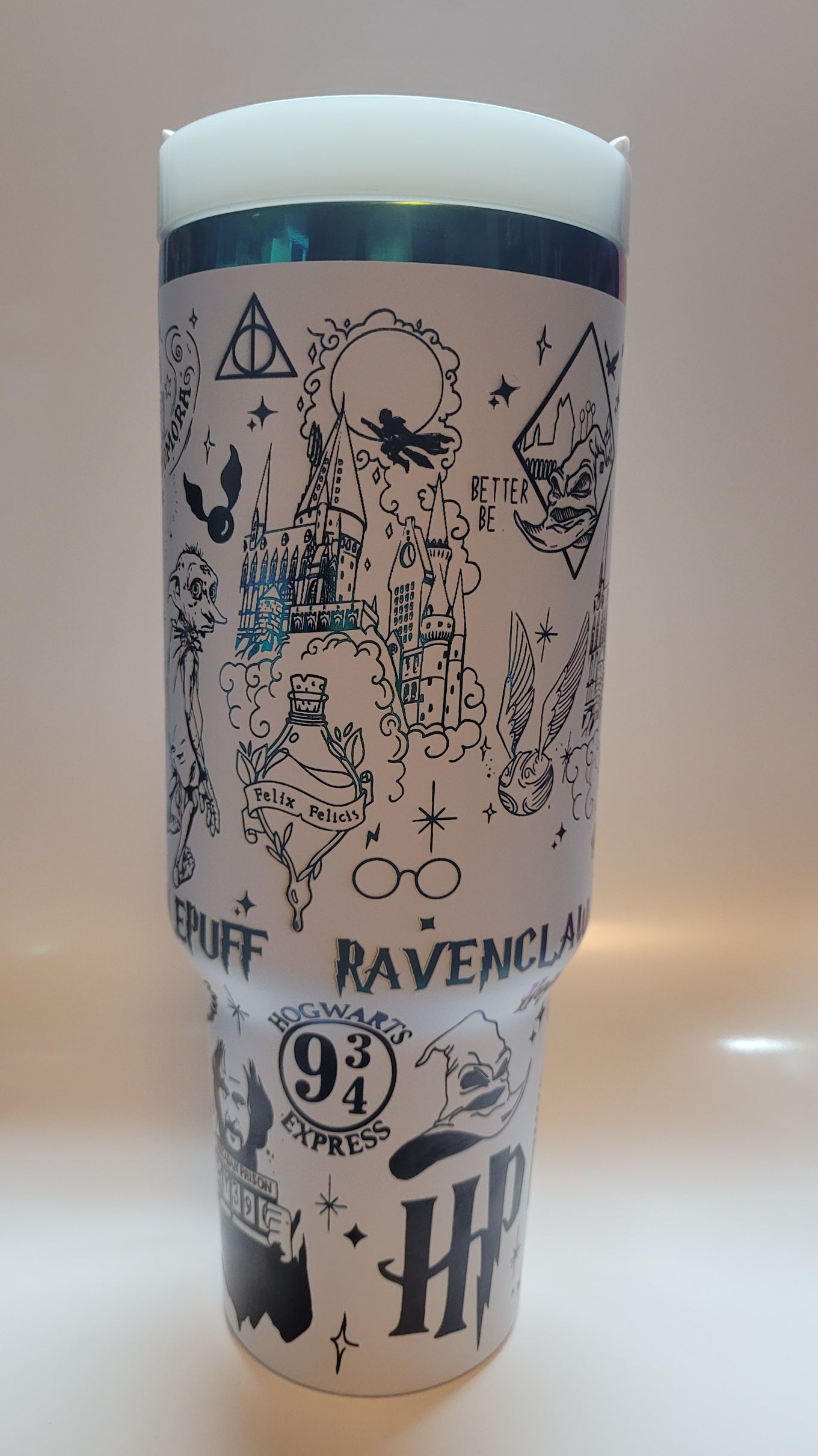Tumbler with Harry Potter-themed designs on a white background