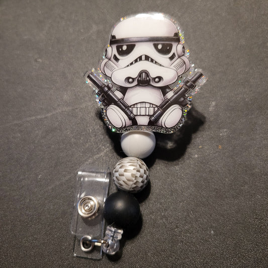 Stormtrooper badge holder with decorative elements on a dark background