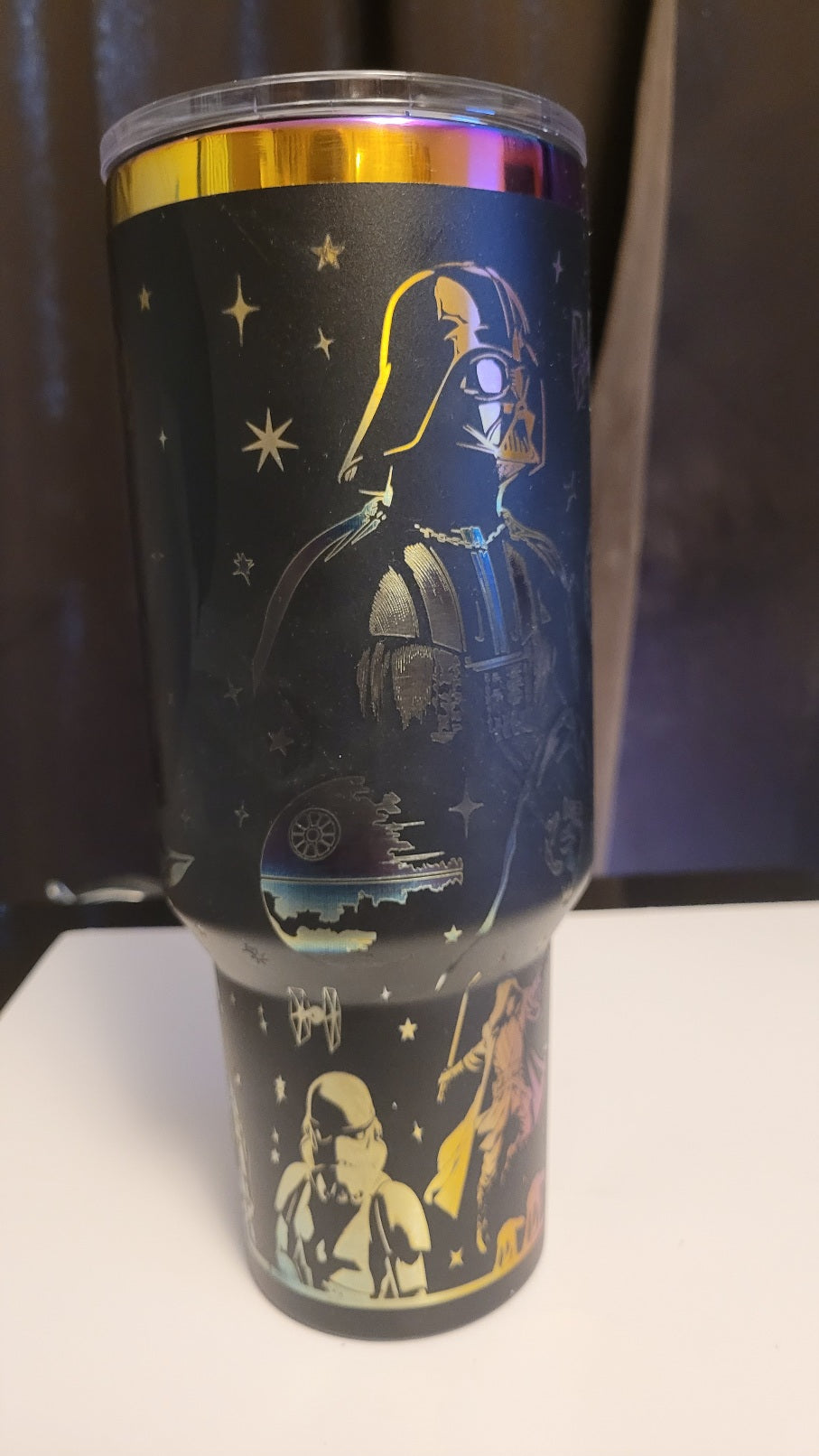 Tumbler with Star Wars design featuring Darth Vader and other characters on a dark background.
