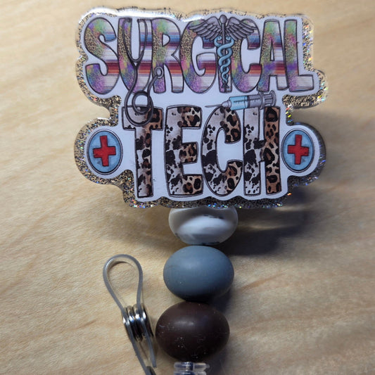 Badge holder with 'Surgical Tech' text and medical symbols on a beige background