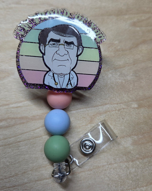 Badge holder with colorful beads and a printed image on a wooden surface