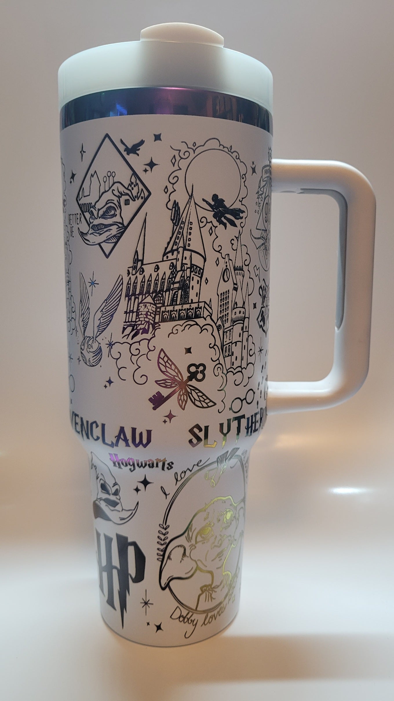 White mug with Harry Potter-themed designs on a light background