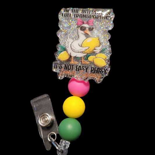 Colorful badge holder with a cartoon duck design on a dark background