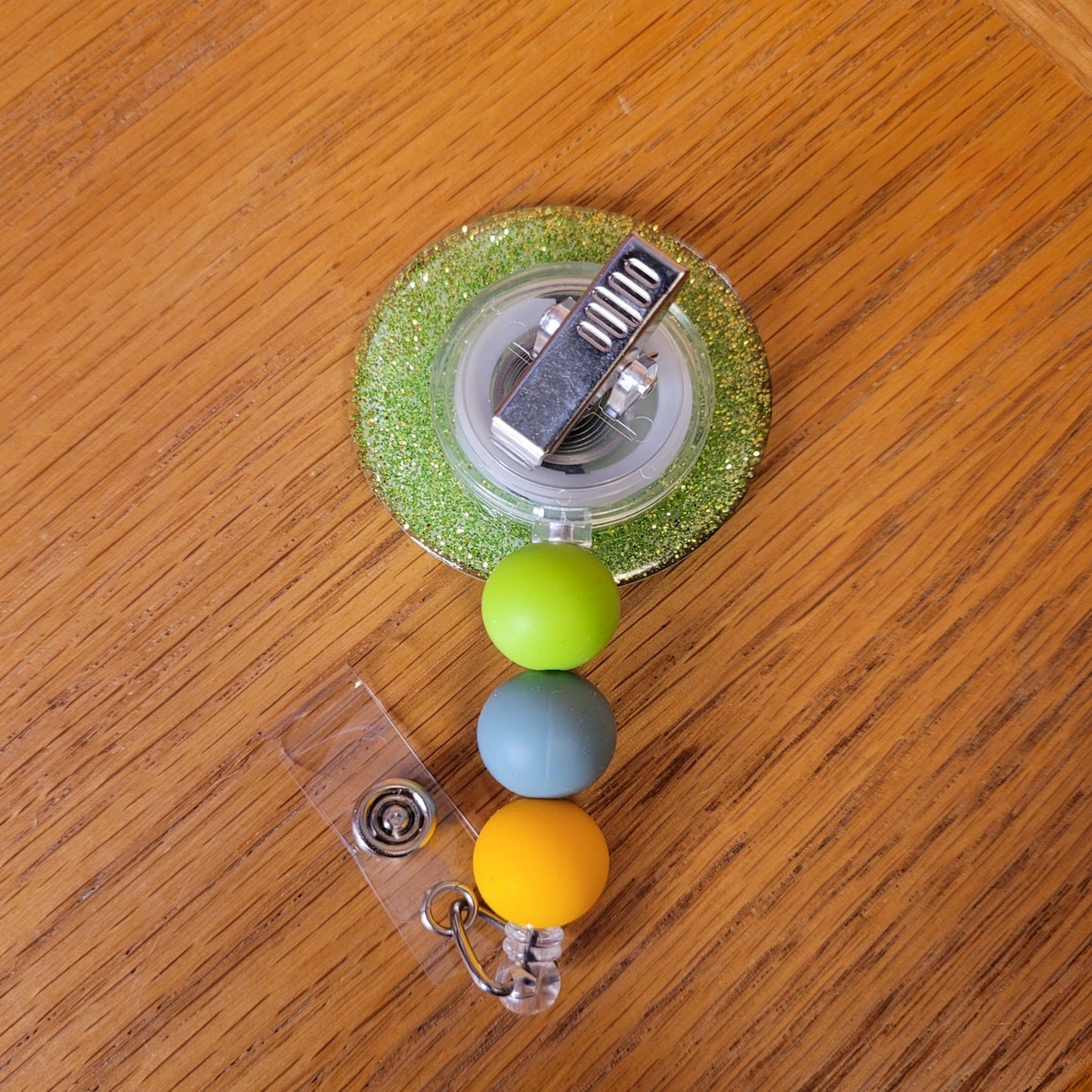 Another new one to our Animal Series... Portrait Of A Frog. This badge reel features a round design with a smiling from posing in a ring of flowers for a special photo op.