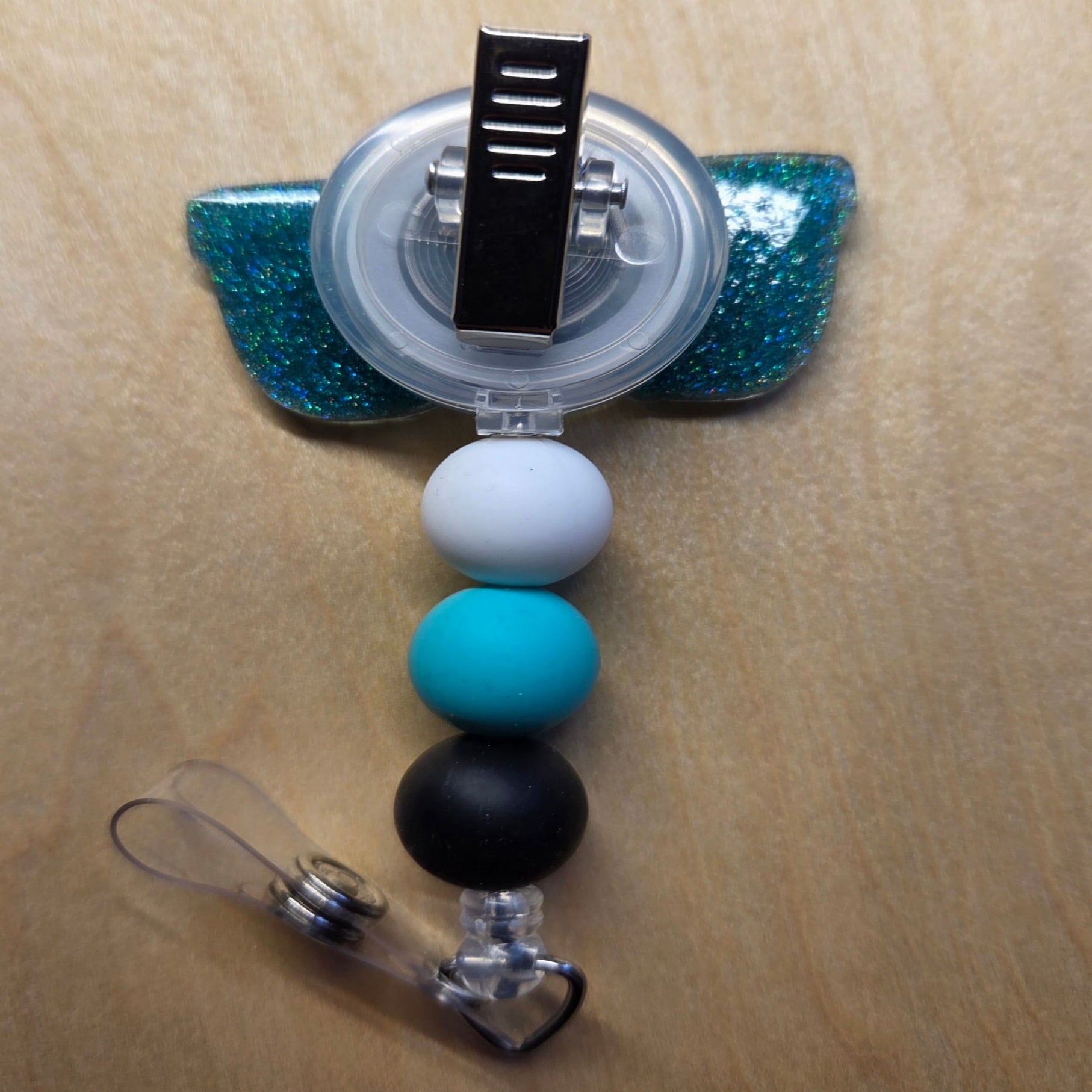 Lanyard holder with colorful beads on a wooden surface