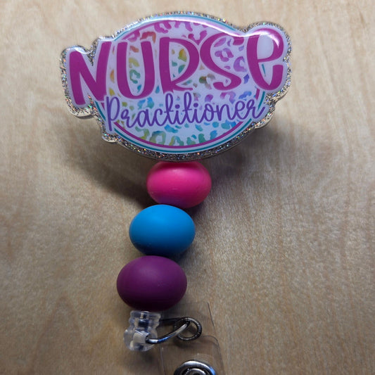 Colorful badge holder with 'Nurse Practitioner' text on a wooden surface
