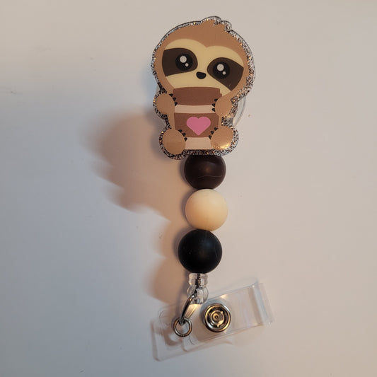 Sloth-themed badge holder with colorful beads on a white background