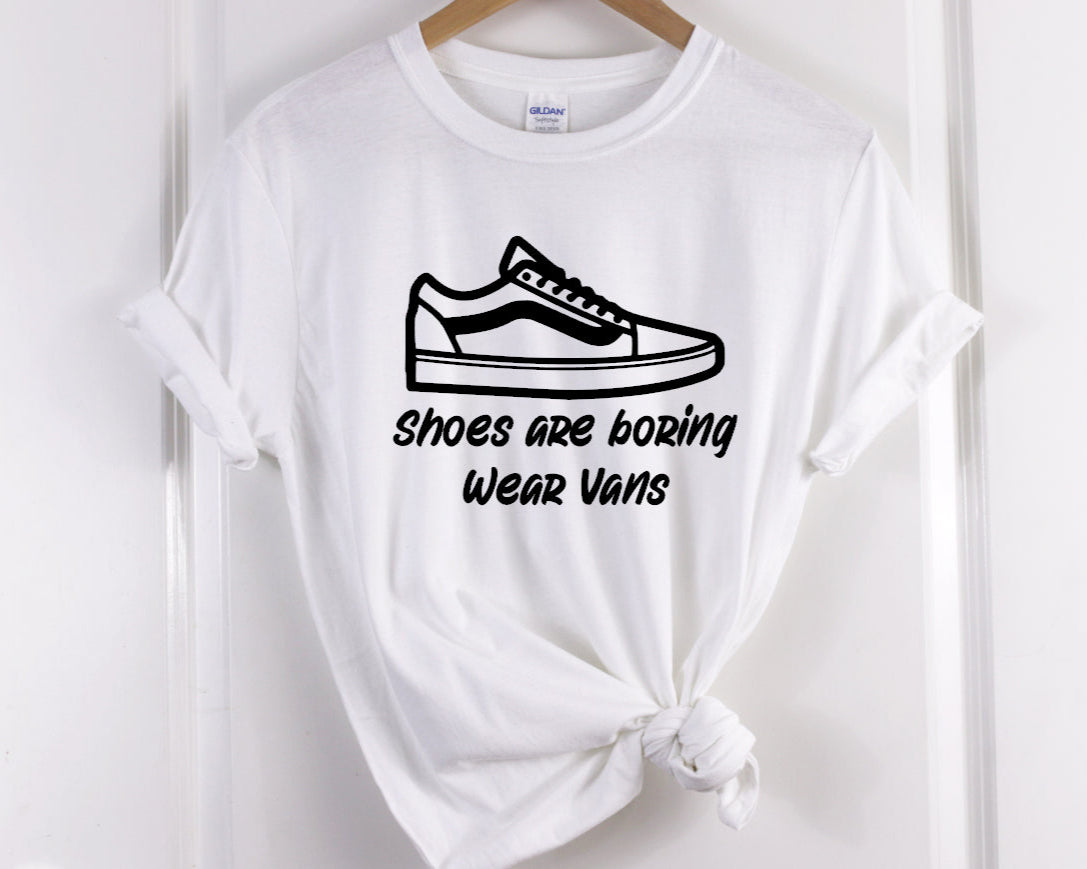 Our T-shirt features a Screen Print Transfer of black lettering with the phrase "Shoes Are Boring Wear Vans." This Unisex adult-sized shirt is made of 5.3 oz. of pre-shrunk 100% cotton.